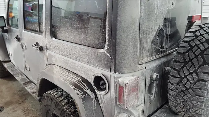 a car covered with salt that require a professional wash service