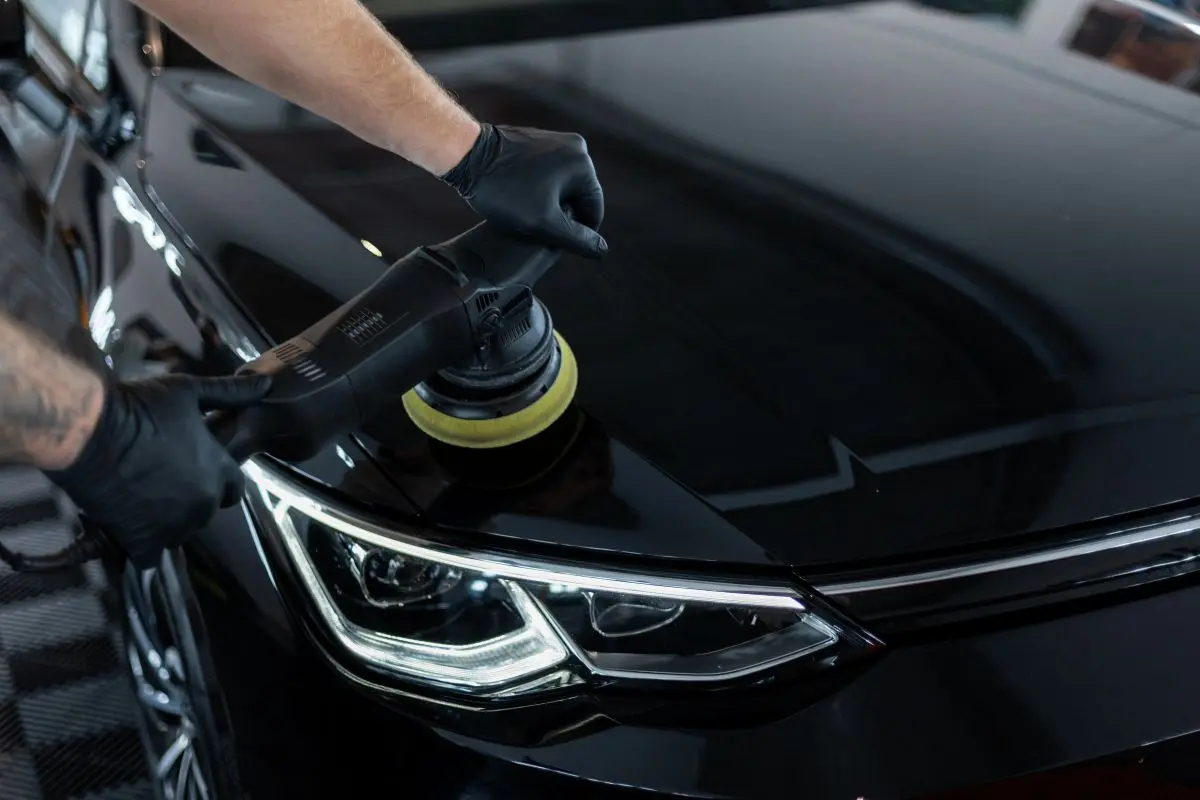 professional man polishing black car car care polishing scratch removal detailing